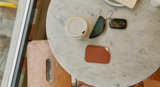 a table topped with a phone and a cup of coffee