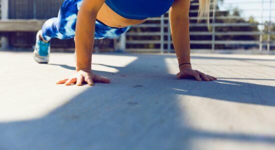 woman planking on gray asphalt road